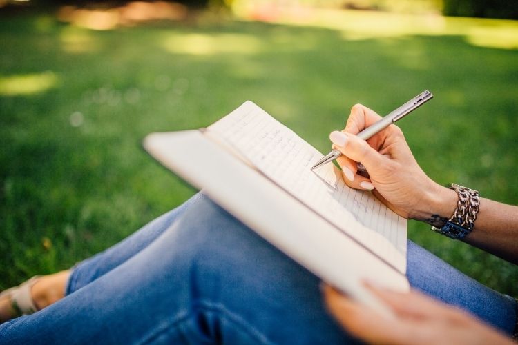 woman writing fitness goals